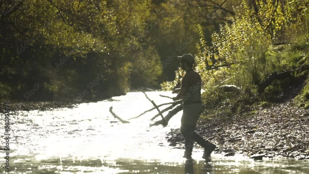 Fisherman with fishing rod casting line Kawarau River Fisherman with fishing rod casting line Kawarau River
