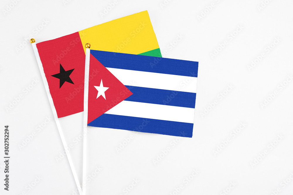 Cuba and Guinea Bissau stick flags on white background. High quality fabric, miniature national flag. Peaceful global concept.White floor for copy space. Cuba and Guinea Bissau stick flags on white background. High quality fabric, miniature national flag. Peaceful global concept.White floor for copy space.