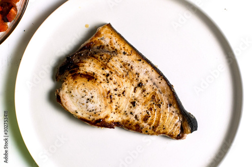 Overhead view of pan seared swordfish on plate