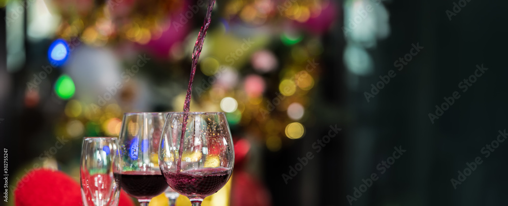 Christmas decoration with two glasses of champagne or wine with blur Christmas tree with bokeh on background