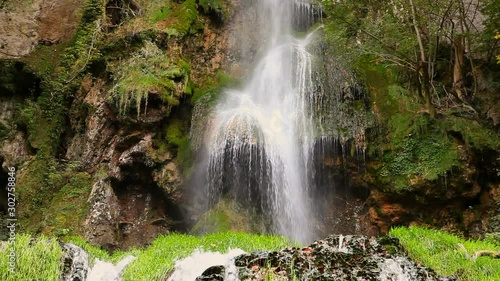 detail close up of serene small waterfall in autumn forest in urach schwäbische alb germany photo