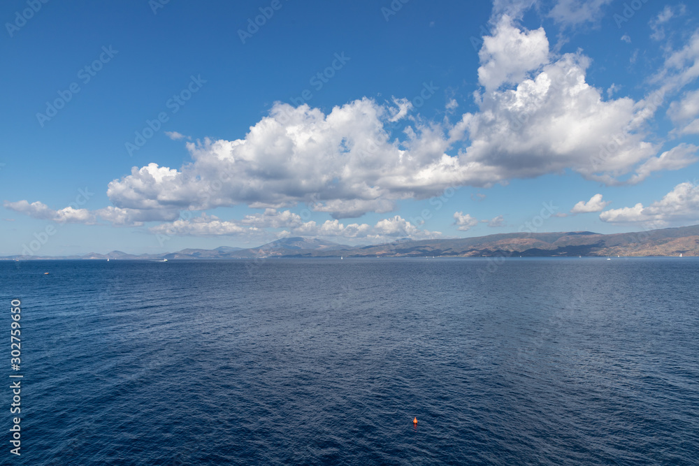 Ocean and clouds reflected with Greece continental in background from Hydra Island
