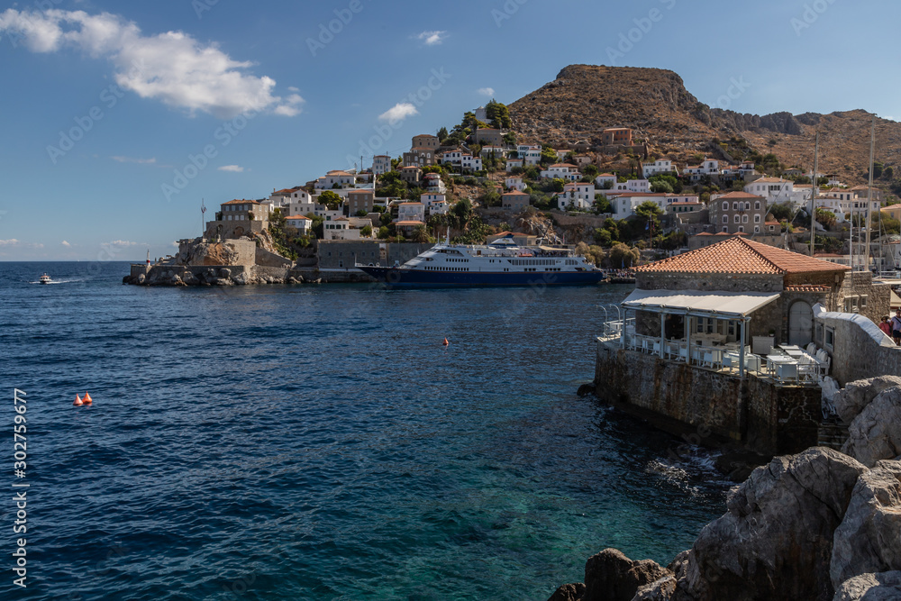 Cruise ship and buildings around pier in Hydra Island