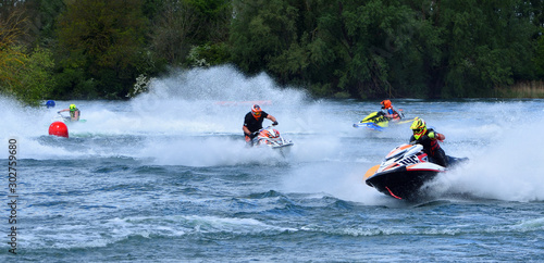  Jet Ski  race competitors cornering at speed creating at lot of spray. photo