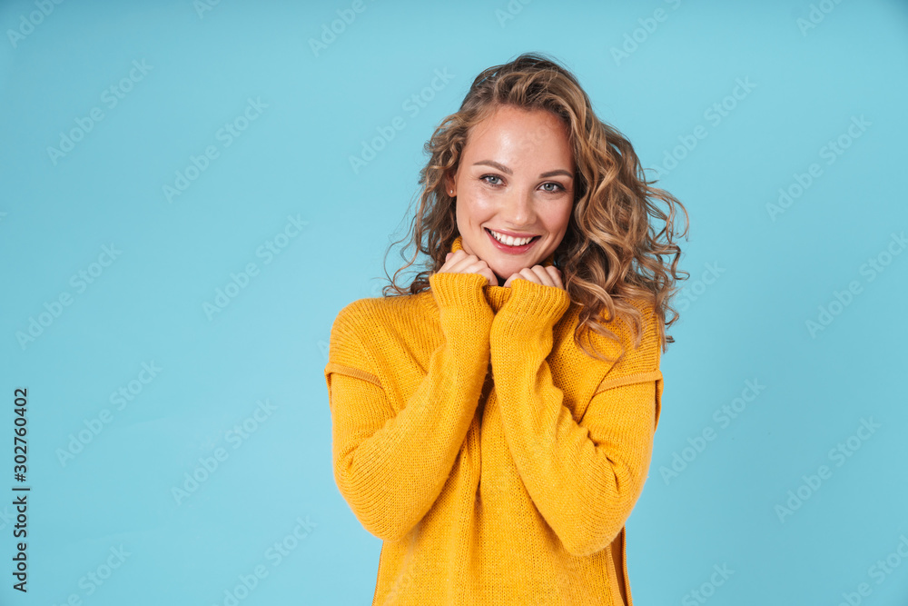 Cheerful lovely young girl wearing sweater standing Cheerful lovely young girl wearing sweater standing