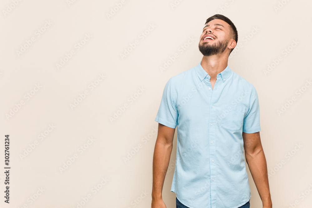 Fototapeta premium Young south-asian man relaxed and happy laughing, neck stretched showing teeth.