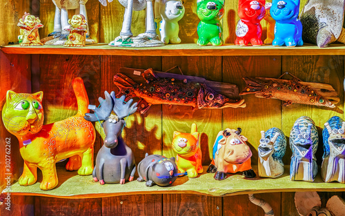 Ceramic cats souvenirs in stall during the Christmas market in winter Riga in Latvia. Europe in winter. German street Xmas and holiday fair. Advent Decoration and Stalls with Crafts Items on Bazaar