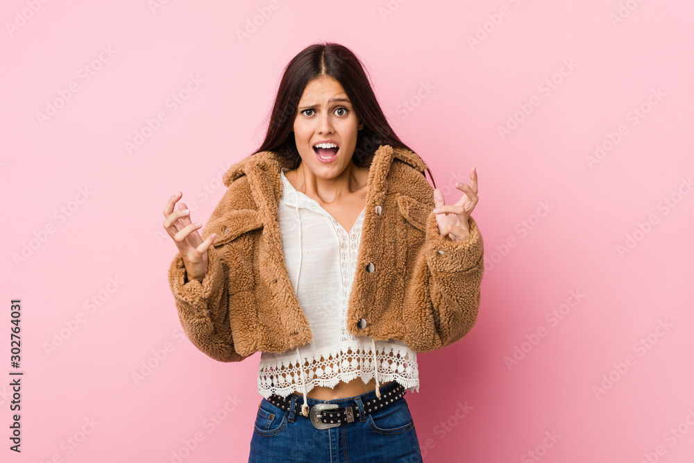 Young cute woman screaming with rage. Young cute woman screaming with rage.