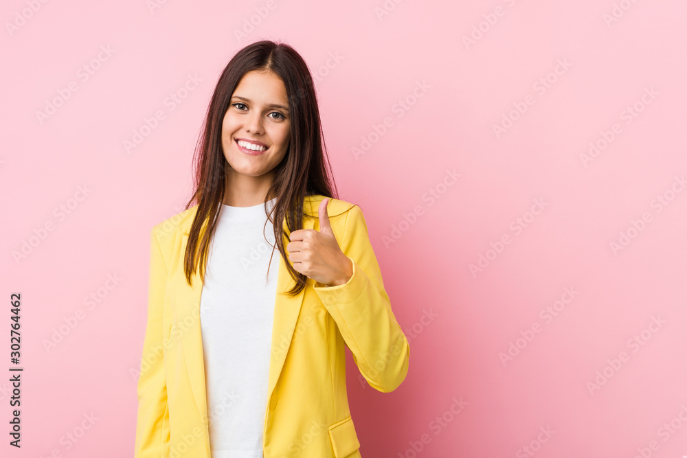 Young business woman smiling and raising thumb up Young business woman smiling and raising thumb up