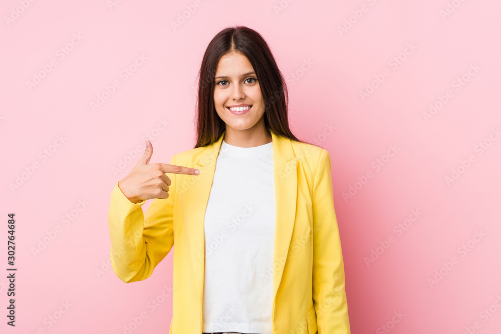 Young business woman person pointing by hand to a shirt copy space, proud and confident Young business woman person pointing by hand to a shirt copy space, proud and confident