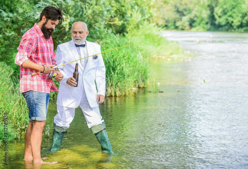 Fishing excuse drinking. Bearded man and elegant businessman fishing together. Cheers. Men relaxing nature background. Fun and relax. Weekend time. Fishing skills. Summer weekends or vacation