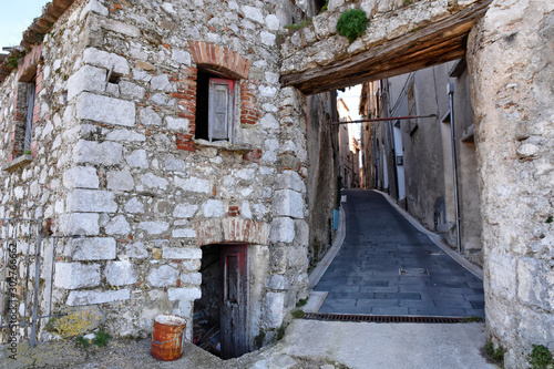 Caggiano, Italy, 01/18/2018. A road through the old houses of a mountain village. photo