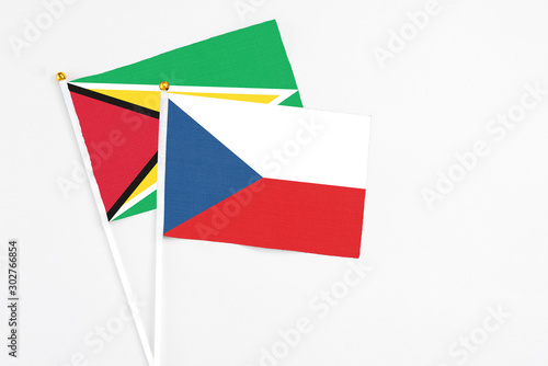 Czech Republic and Guyana stick flags on white background. High quality fabric, miniature national flag. Peaceful global concept.White floor for copy space.