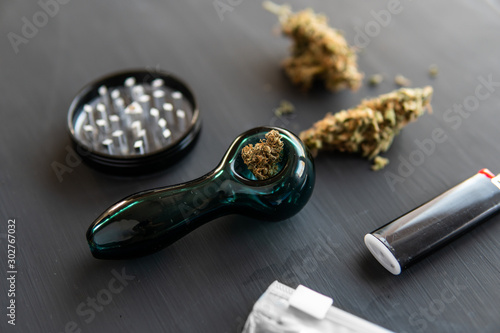 Marijuana smoking pipe Cannabis buds weed on black wood background. CBD and THC on buds in cannabis. Marijuana grinder Fresh marihuana. Cannabis legalisation. photo