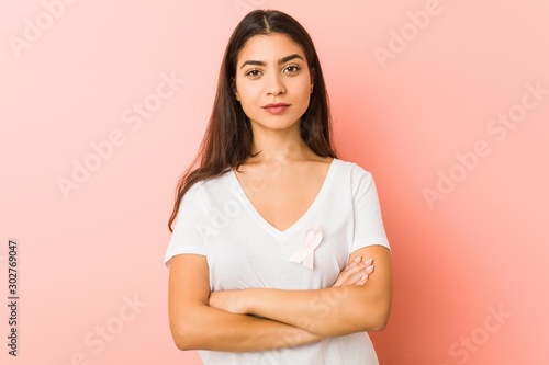 Young arab woman with a pink bow. Concept of fight against cancer. © Asier