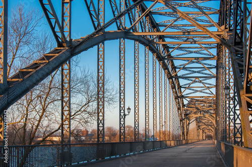 The old Harburger elbe bridge in a sunsetlight, a steel arch bridge connecting the Hamburg districts of Harburg and Wilhelmsburg via the southern Elbe. photo