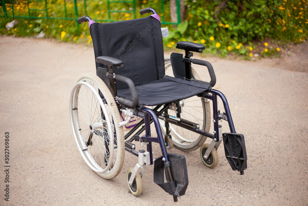 Wheelchair on the street. Chair for a person with disabilities. Wheelchair on the street. Chair for a person with disabilities.