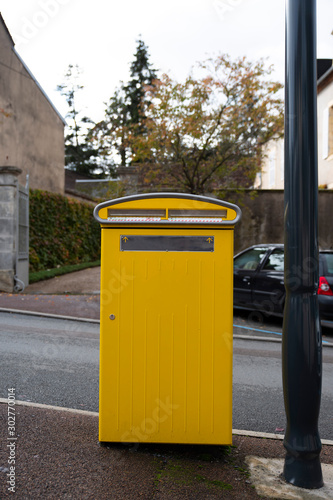 Yellow French letterboxes in a city center in village