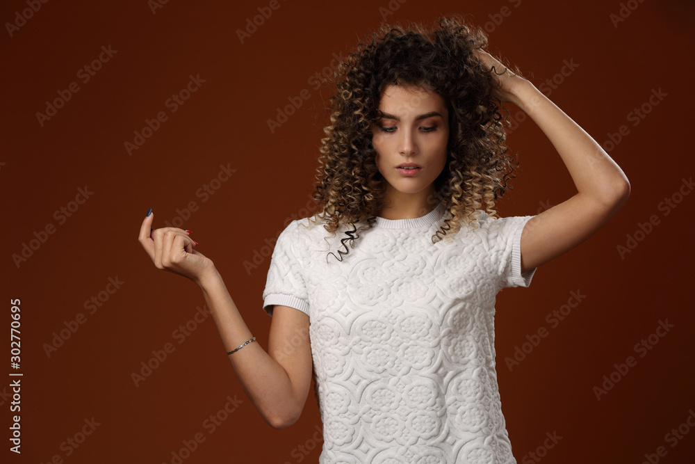 Beautiful girl in white dress on maroon background Beautiful girl in white dress on maroon background