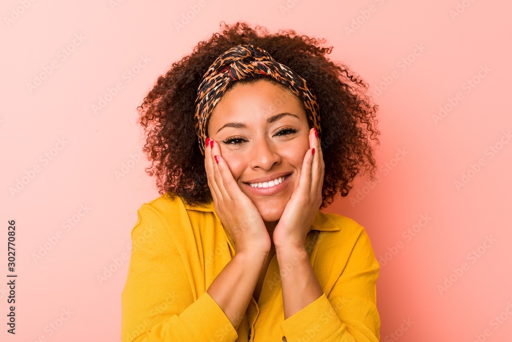 Young african american woman against a pink background Young african american woman against a pink background