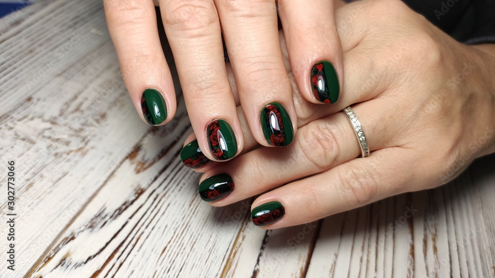 Beautiful nail design on female hands on background.