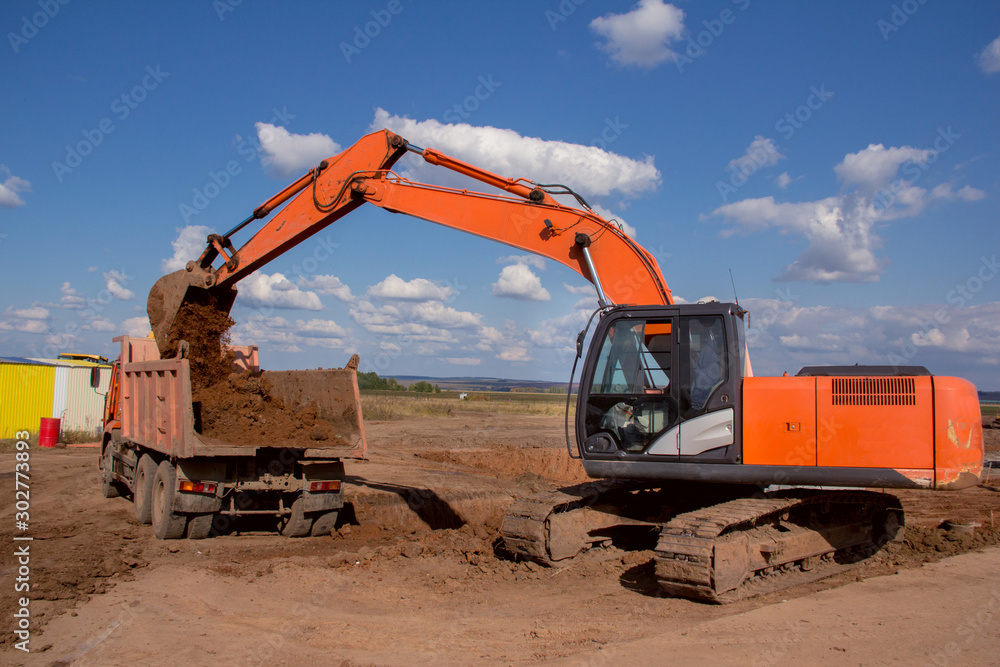 Industrial excavator on a construction site. Special equipment on the background of the landscape Industrial excavator on a construction site. Special equipment on the background of the landscape