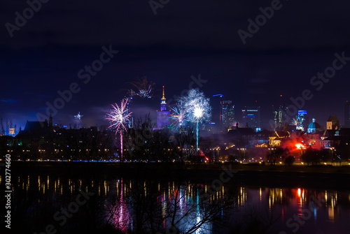 Photography New Year's fireworks show in Warsaw, Poland at night, view from the Vistula Rive