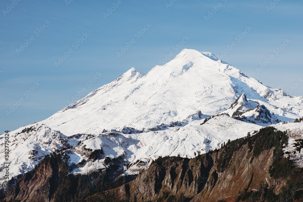 Snowy mountain peak closeup. Coleman glacier on top of Mount Baker in Cascade Mountains. Mount Baker National Forest. Snowy mountain in Washington. The most beautiful snow peak.