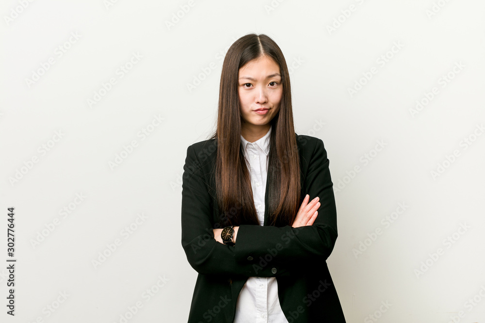 Young pretty chinese business woman unhappy looking in camera with sarcastic expression. Young pretty chinese business woman unhappy looking in camera with sarcastic expression.