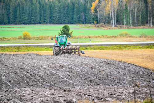 ploughman ploughing a field in Varmland Sweden