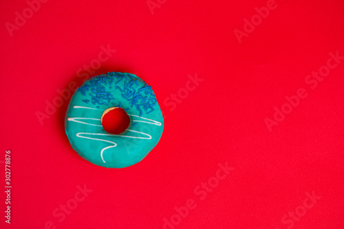 Donut with mint icing on a red background photo