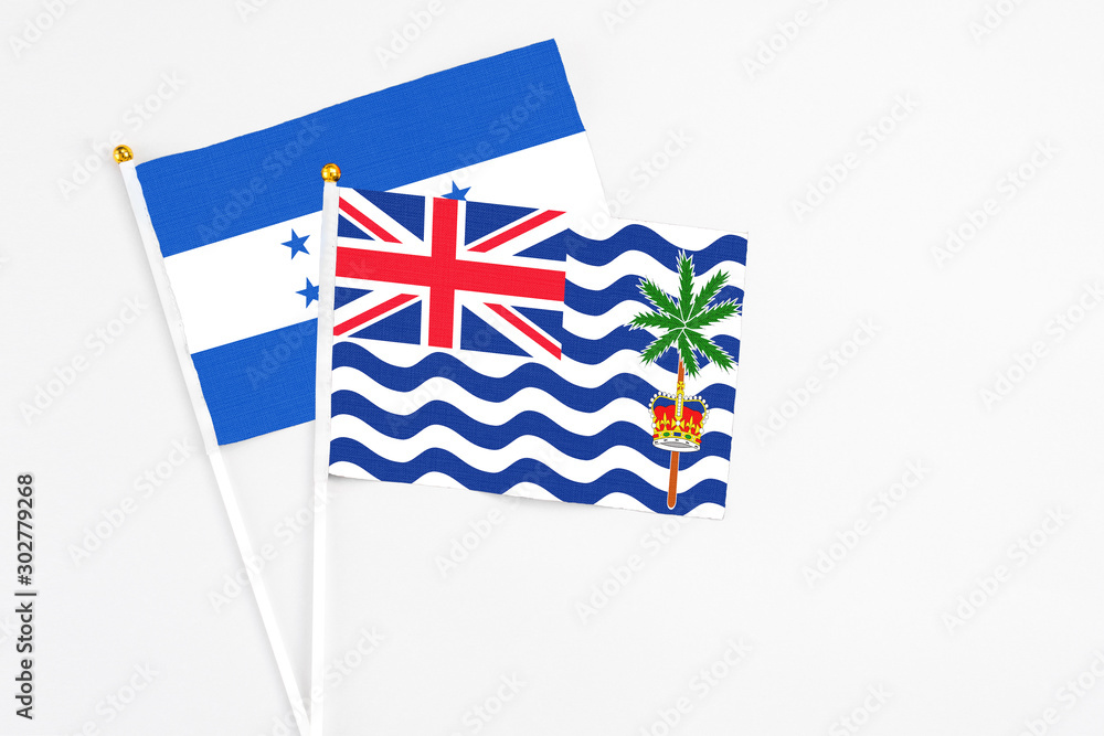 British Indian Ocean Territory and Honduras stick flags on white background. High quality fabric, miniature national flag. Peaceful global concept.White floor for copy space. British Indian Ocean Territory and Honduras stick flags on white background. High quality fabric, miniature national flag. Peaceful global concept.White floor for copy space.