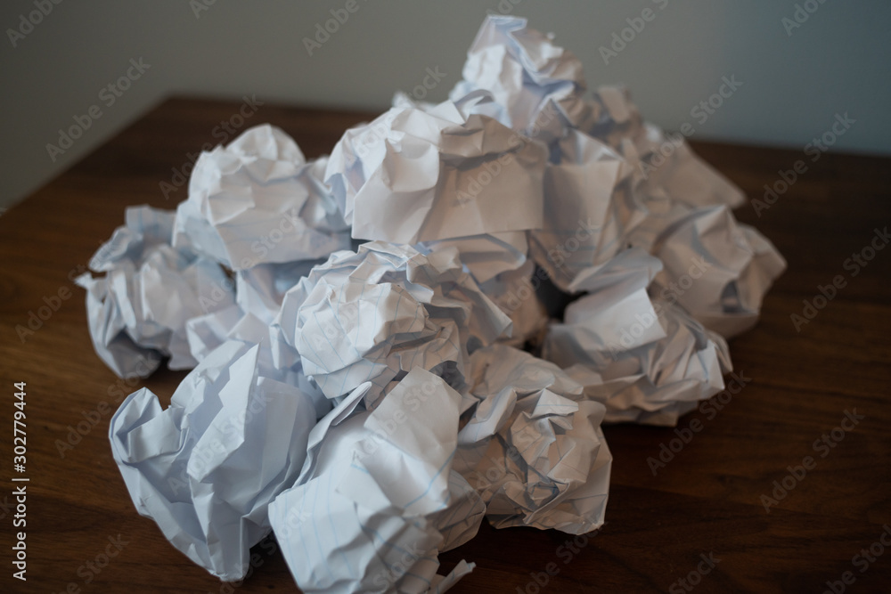 Essay with crumpled papers stacked behind