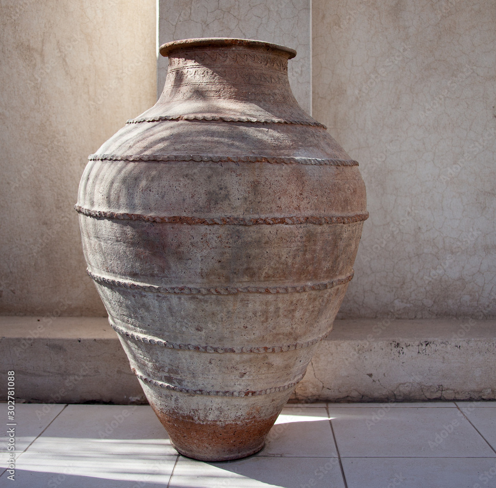Large Arabic vase against a textured wall Stock Photo | Adobe Stock