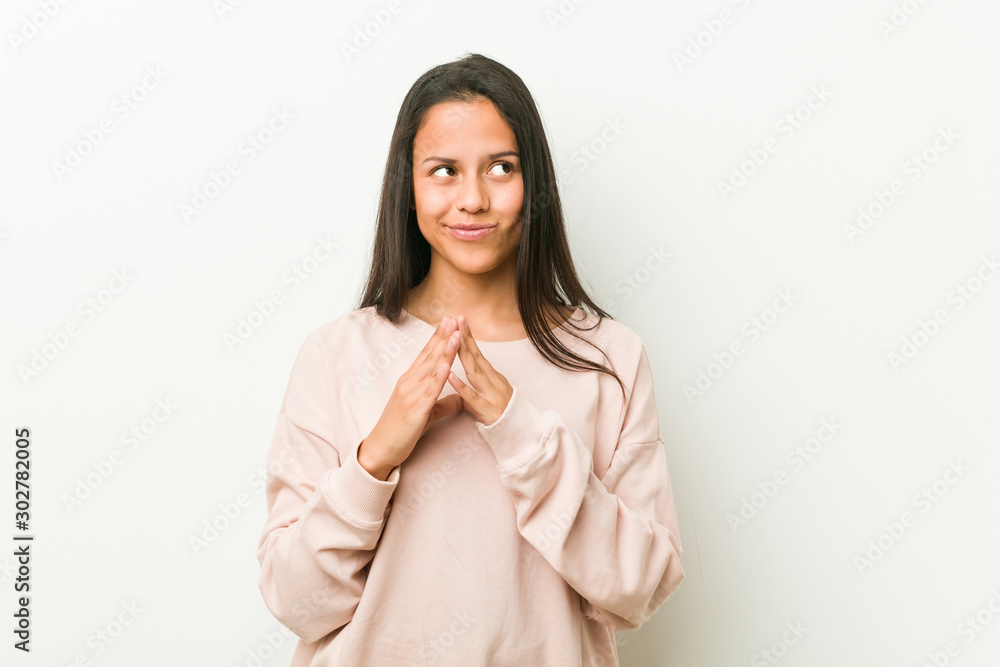 Young cute hispanic teenager woman making up plan in mind, setting up an idea. Young cute hispanic teenager woman making up plan in mind, setting up an idea.