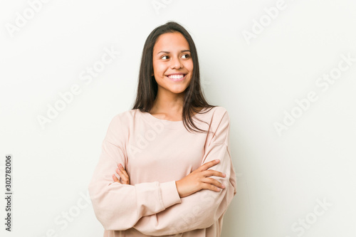 Young cute hispanic teenager woman smiling confident with crossed arms. © Asier