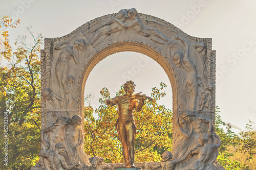 Monument of an golden Johan Strauss in the Stadtpark in Vienna photo