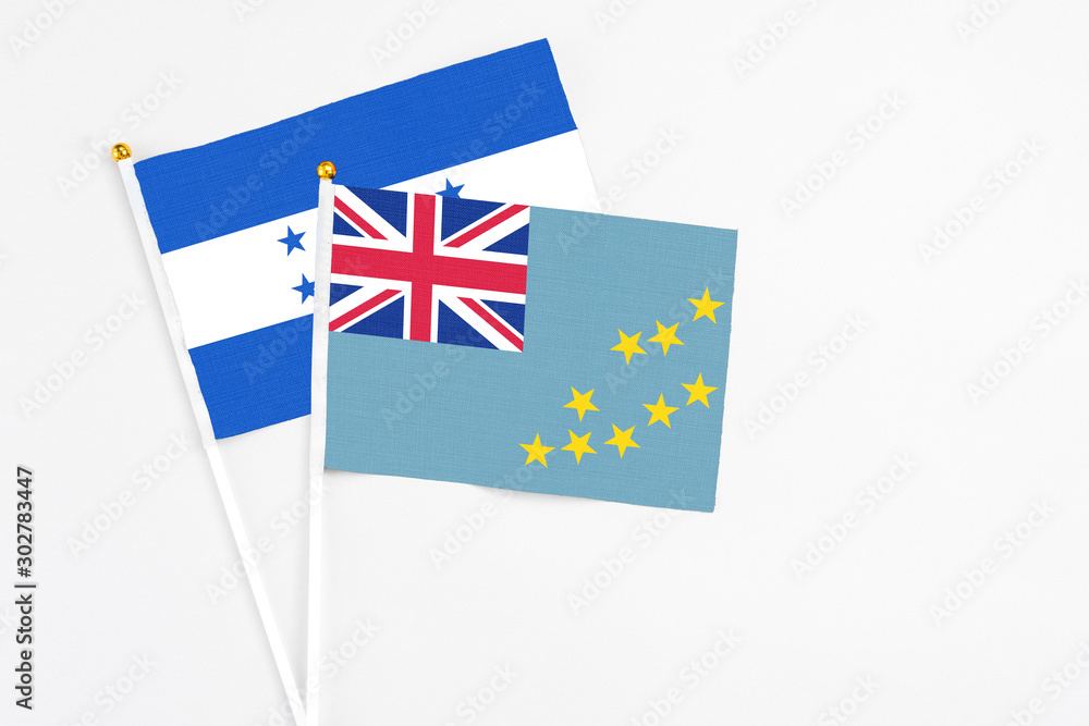 Tuvalu and Honduras stick flags on white background. High quality fabric, miniature national flag. Peaceful global concept.White floor for copy space. Tuvalu and Honduras stick flags on white background. High quality fabric, miniature national flag. Peaceful global concept.White floor for copy space.