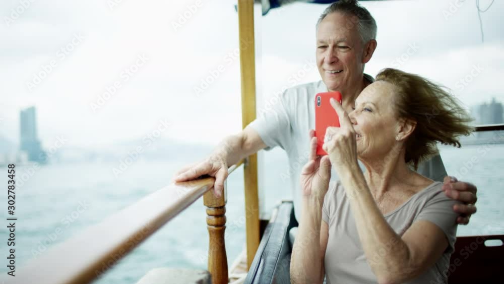 Senior couple taking travel photos with smart phone Senior couple taking travel photos with smart phone
