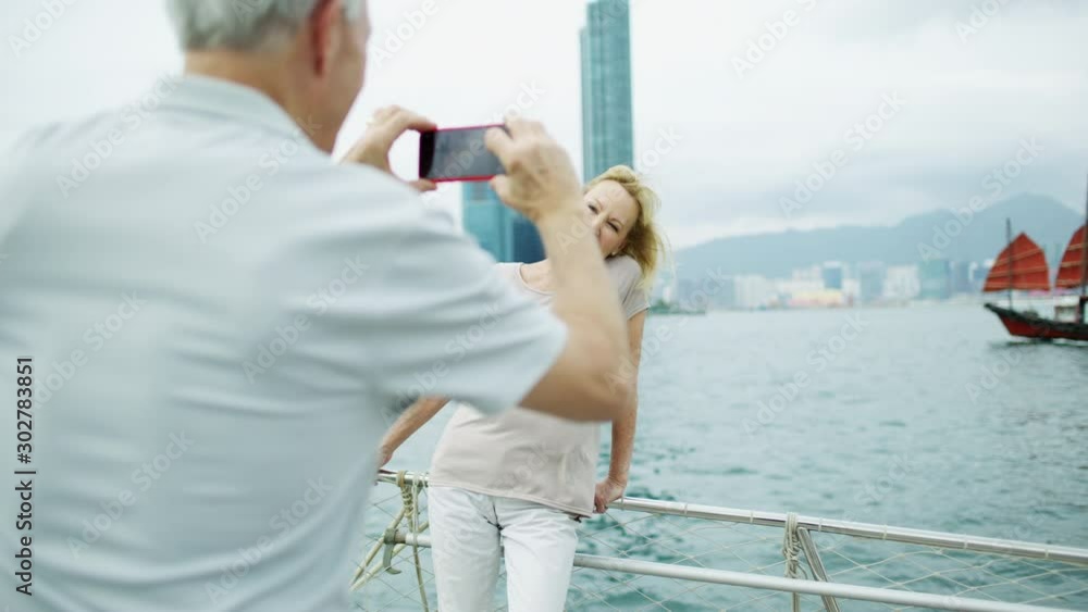 Senior couple taking travel photos with smart phone Senior couple taking travel photos with smart phone