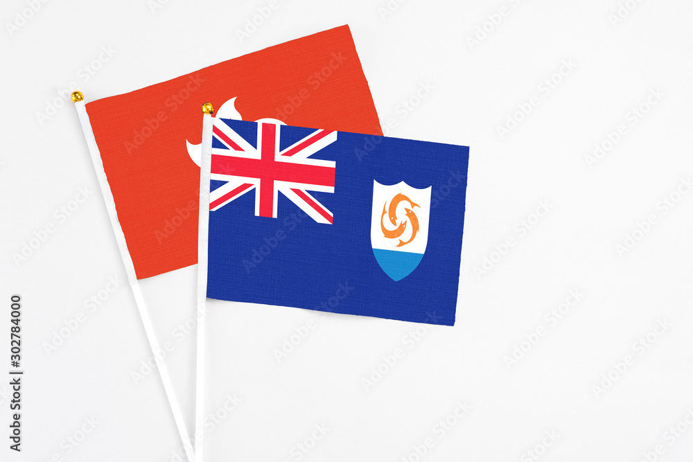 Anguilla and Hong Kong stick flags on white background. High quality fabric, miniature national flag. Peaceful global concept.White floor for copy space. Anguilla and Hong Kong stick flags on white background. High quality fabric, miniature national flag. Peaceful global concept.White floor for copy space.