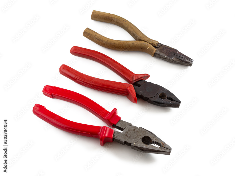 Pliers lie in a row on a white background Pliers lie in a row on a white background