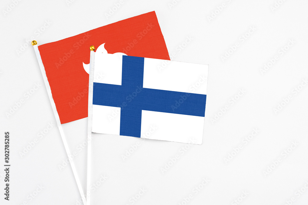 Finland and Hong Kong stick flags on white background. High quality fabric, miniature national flag. Peaceful global concept.White floor for copy space.