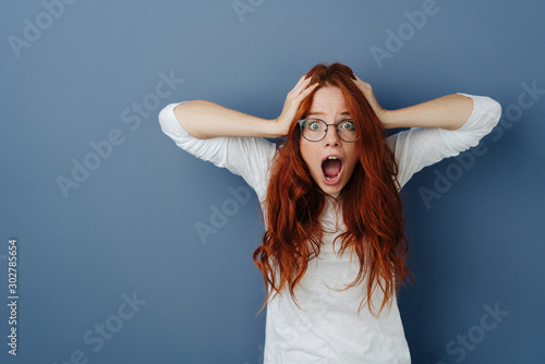 Aghast young woman in a panic