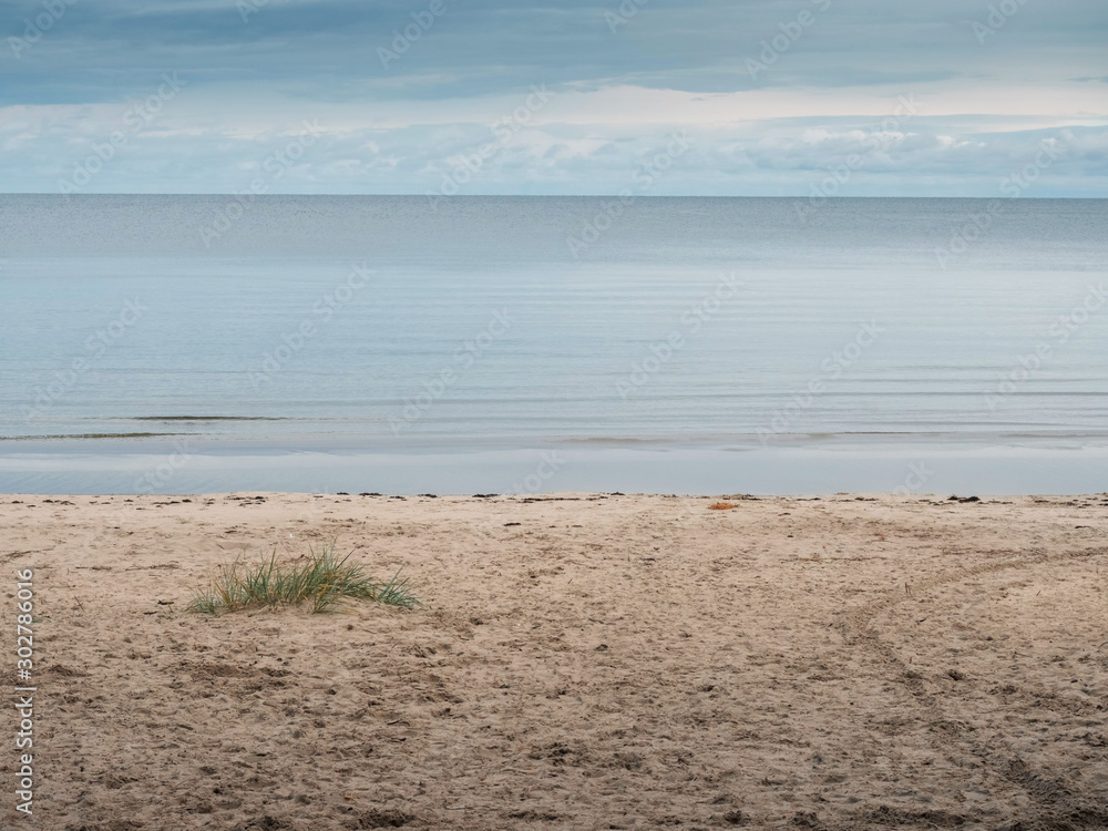 Calm sea surface and cloudy sky, sandy beach, nobody, Jurmala area Latvia. Calm sea surface and cloudy sky, sandy beach, nobody, Jurmala area Latvia.