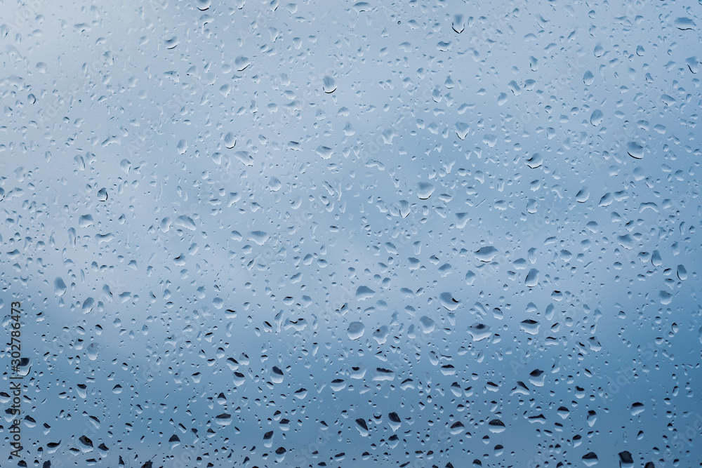 Raindrops on window glass surface, background texture