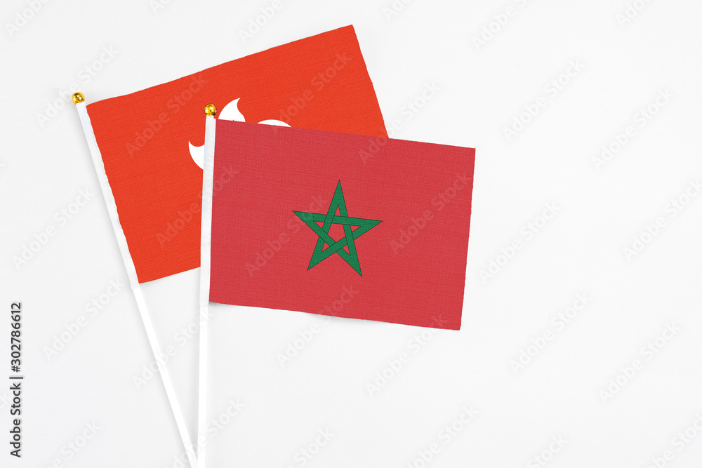 Morocco and Hong Kong stick flags on white background. High quality fabric, miniature national flag. Peaceful global concept.White floor for copy space. Morocco and Hong Kong stick flags on white background. High quality fabric, miniature national flag. Peaceful global concept.White floor for copy space.