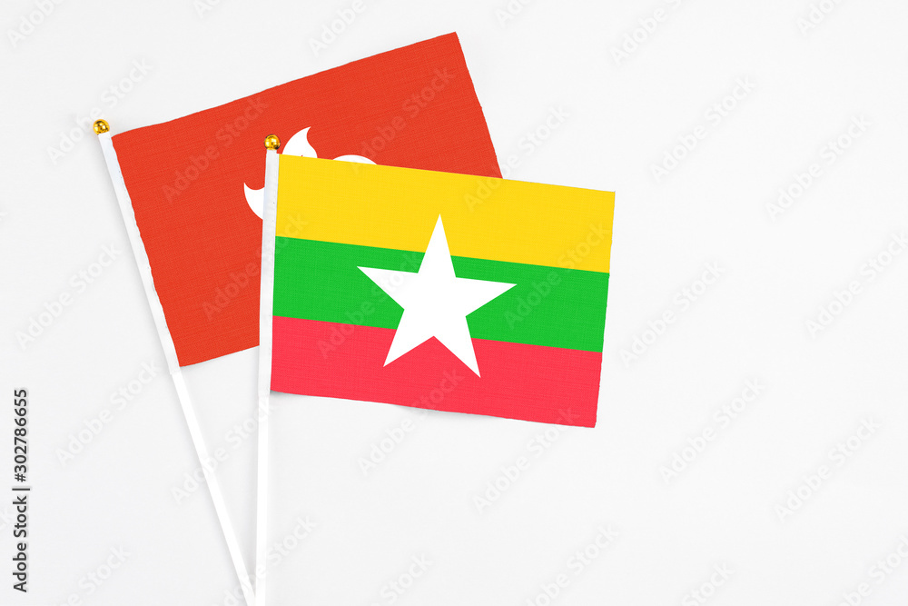 Myanmar and Hong Kong stick flags on white background. High quality fabric, miniature national flag. Peaceful global concept.White floor for copy space. Myanmar and Hong Kong stick flags on white background. High quality fabric, miniature national flag. Peaceful global concept.White floor for copy space.