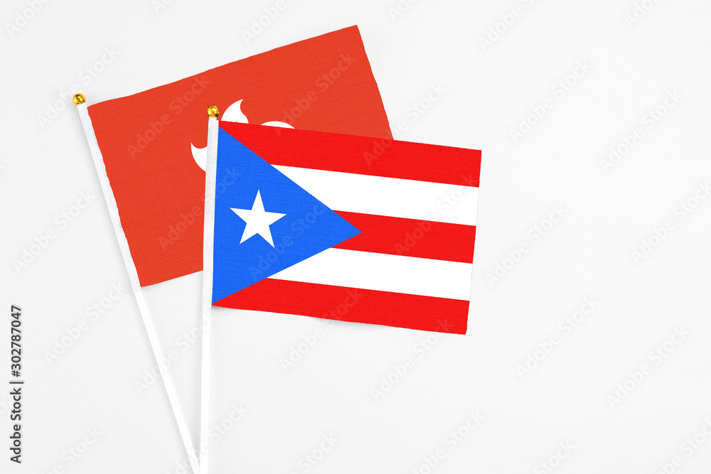 Puerto Rico and Hong Kong stick flags on white background. High quality fabric, miniature national flag. Peaceful global concept.White floor for copy space.