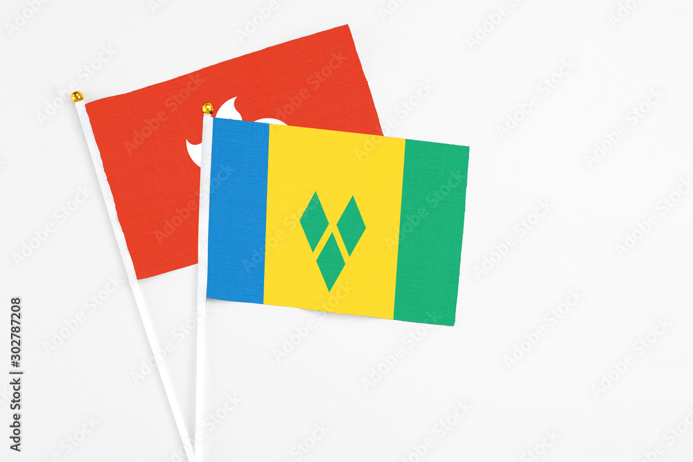 Saint Vincent And The Grenadines and Hong Kong stick flags on white background. High quality fabric, miniature national flag. Peaceful global concept.White floor for copy space. Saint Vincent And The Grenadines and Hong Kong stick flags on white background. High quality fabric, miniature national flag. Peaceful global concept.White floor for copy space.